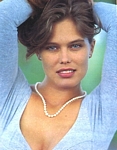 U.K. Hello 2. June 1990 - grey shirt pearl necklace arms up